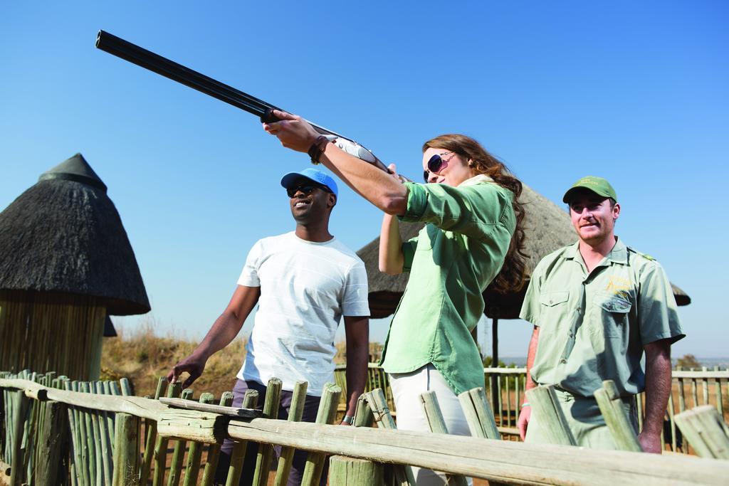 The Palace Of The Lost City At Sun City Resort Экстерьер фото A woman shooting a shotgun